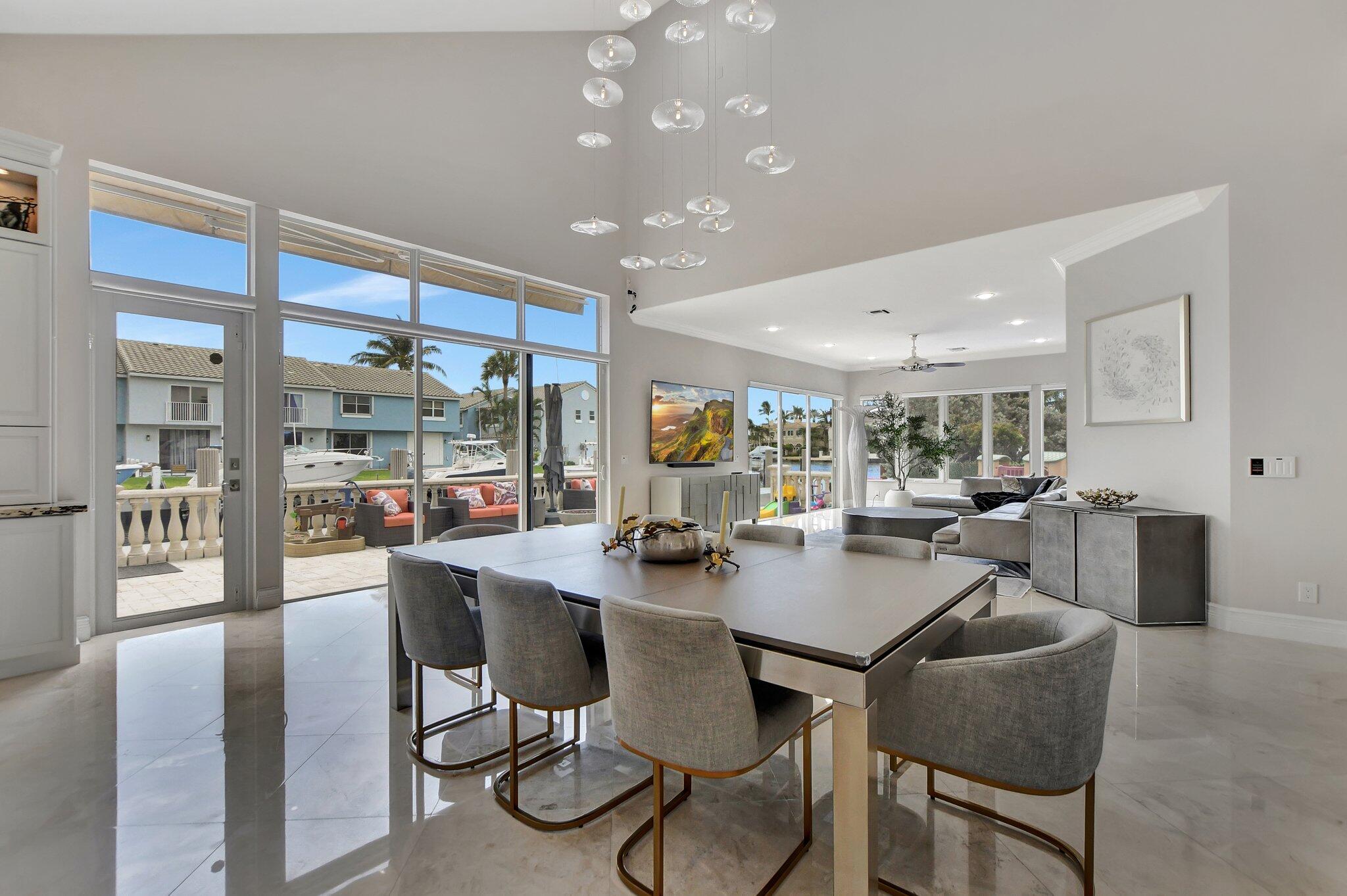 857 Havana Drive Boca Raton, FL 33487 - Photo 3 of 30 a view of a dining room with furniture wooden floor and a large window
