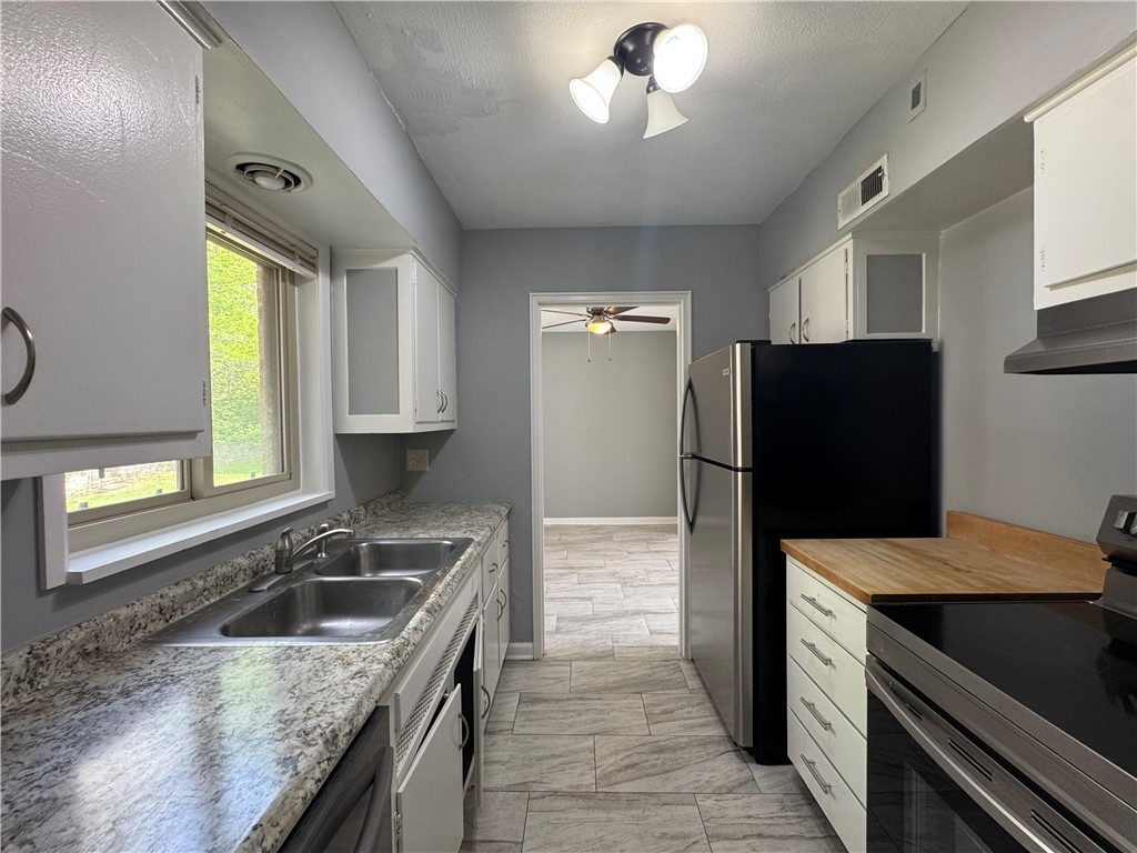 2358 South Patterson Boulevard, Unit 6 Kettering, OH 45409 - Photo 6 of 9 This galley kitchen features durable countertops and sleek appliances, perfect for everyday living.