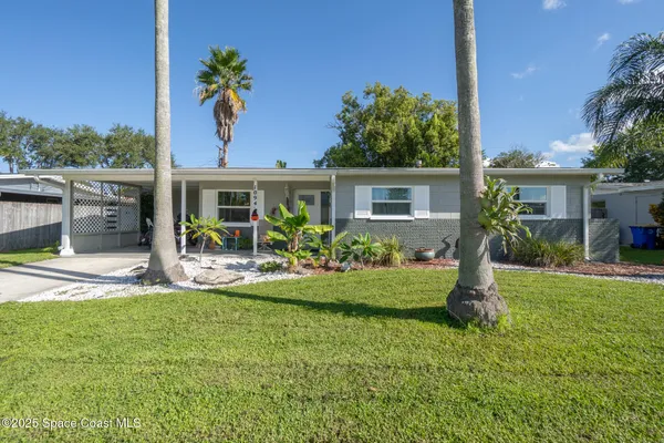 a front view of house with yard and green space