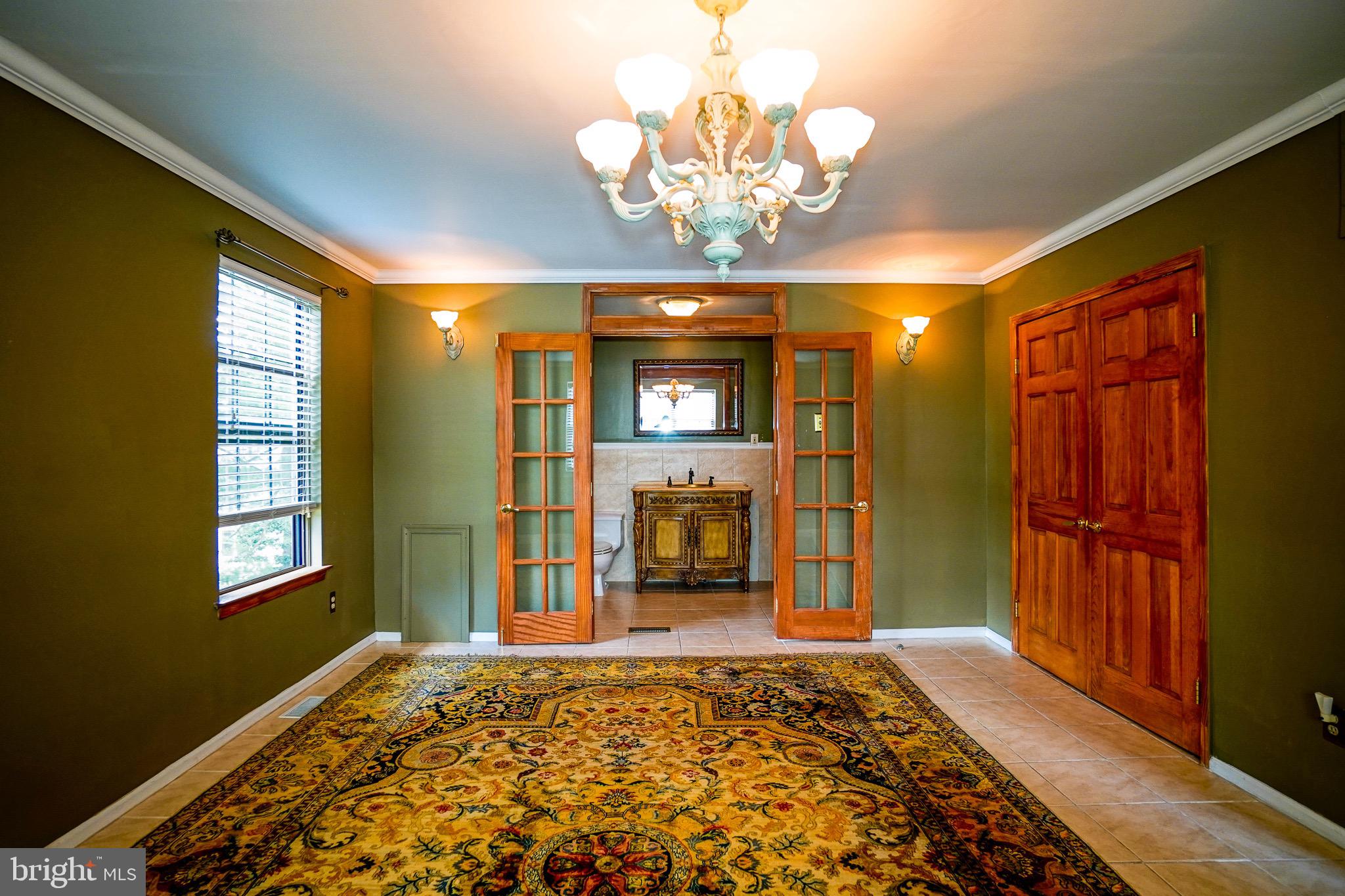 12 Blue Grass Road Clementon, NJ 08021 - Photo 15 of 23 a bedroom with a bed and a chandelier