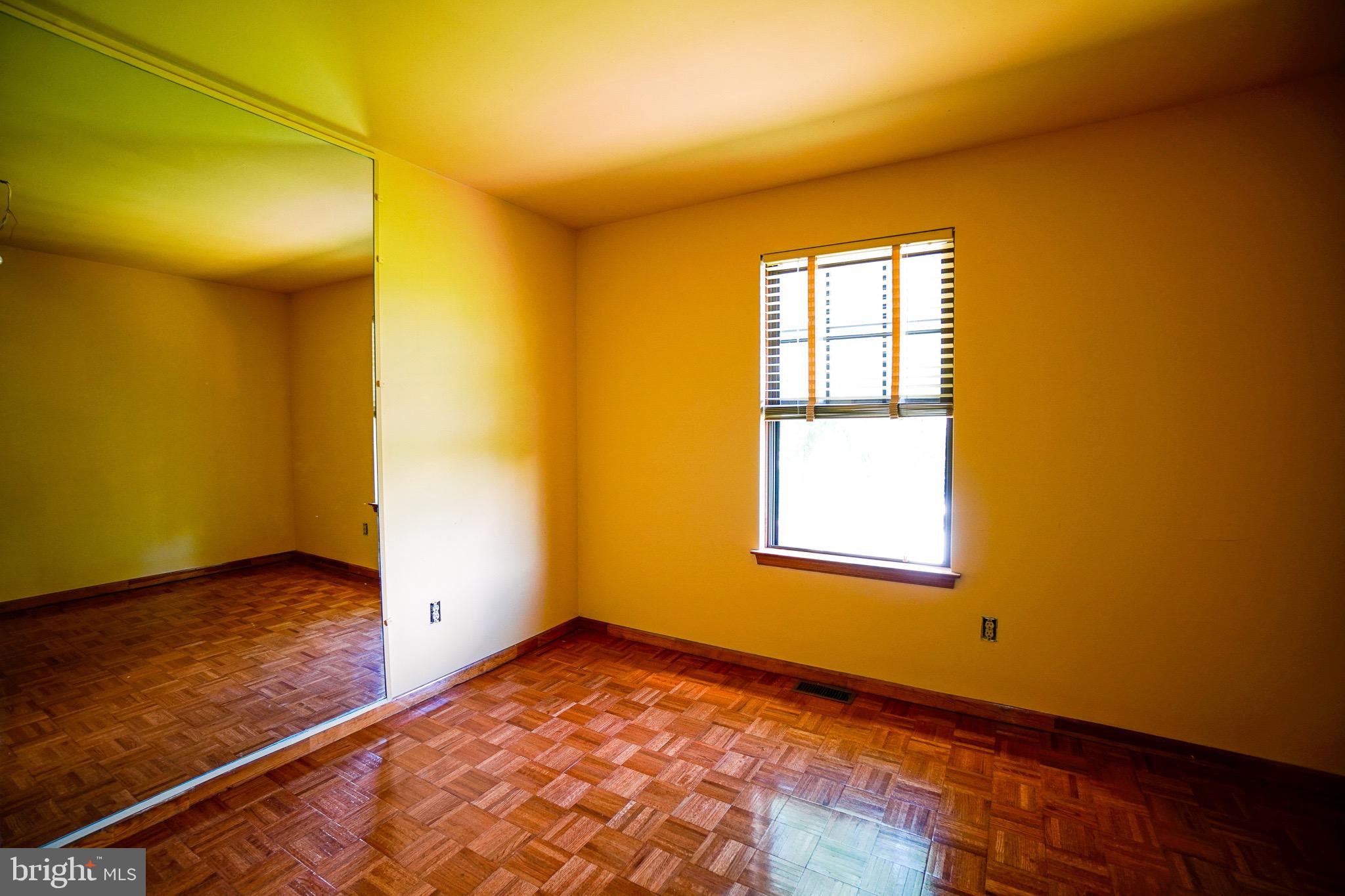 12 Blue Grass Road Clementon, NJ 08021 - Photo 19 of 23 a view of an empty room with wooden floor and a window