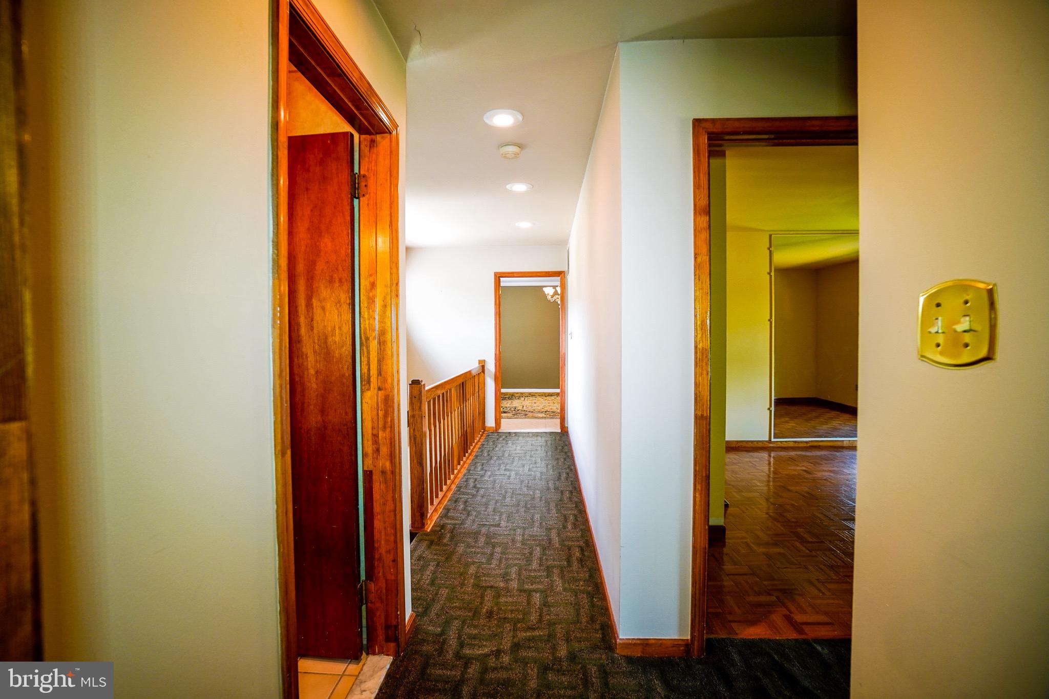12 Blue Grass Road Clementon, NJ 08021 - Photo 21 of 23 a view of a hallway with wooden floor and a bathroom