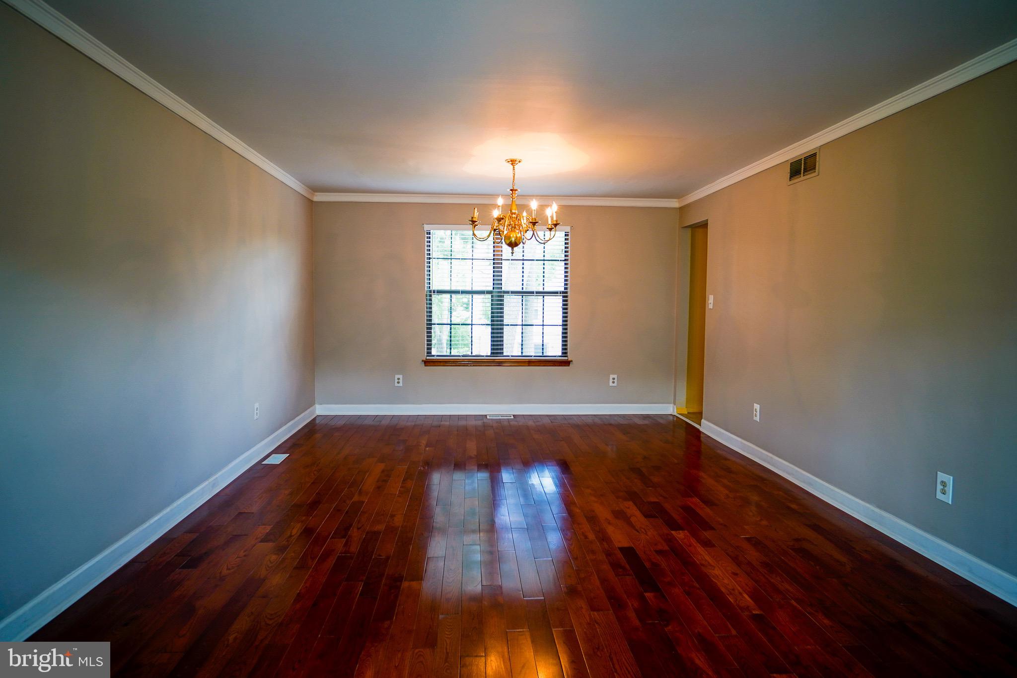12 Blue Grass Road Clementon, NJ 08021 - Photo 4 of 23 a view of empty room with wooden floor and fan