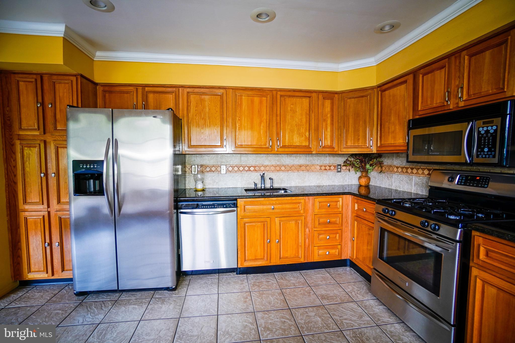 12 Blue Grass Road Clementon, NJ 08021 - Photo 7 of 23 a kitchen with stainless steel appliances granite countertop a refrigerator a stove top oven and a sink