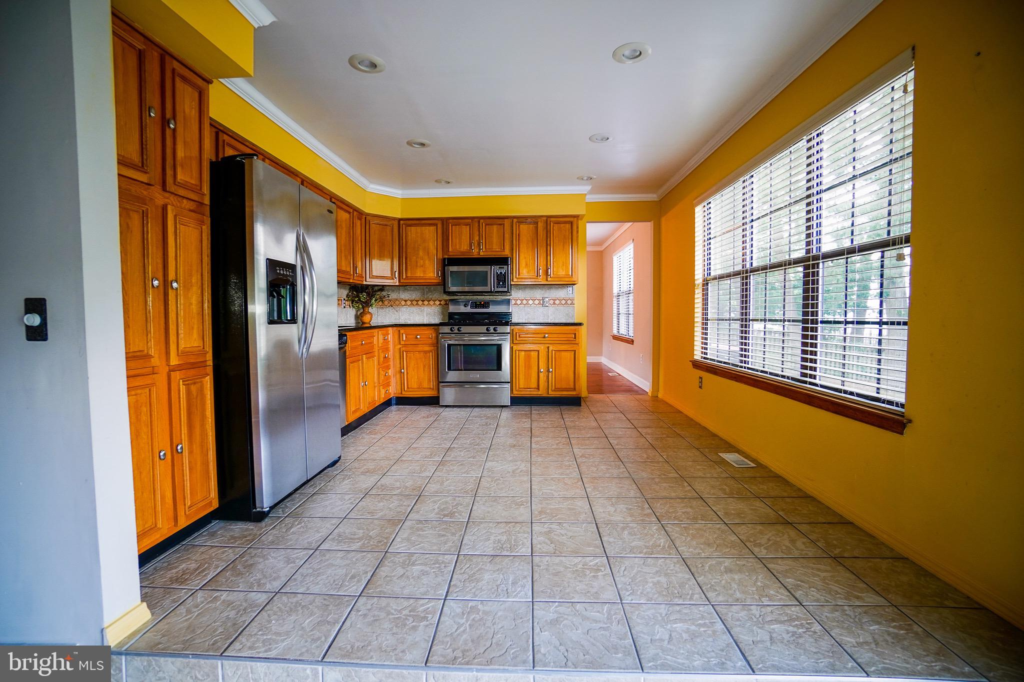 12 Blue Grass Road Clementon, NJ 08021 - Photo 9 of 23 a very nice looking open kitchen with a stove top oven a refrigerator and a window