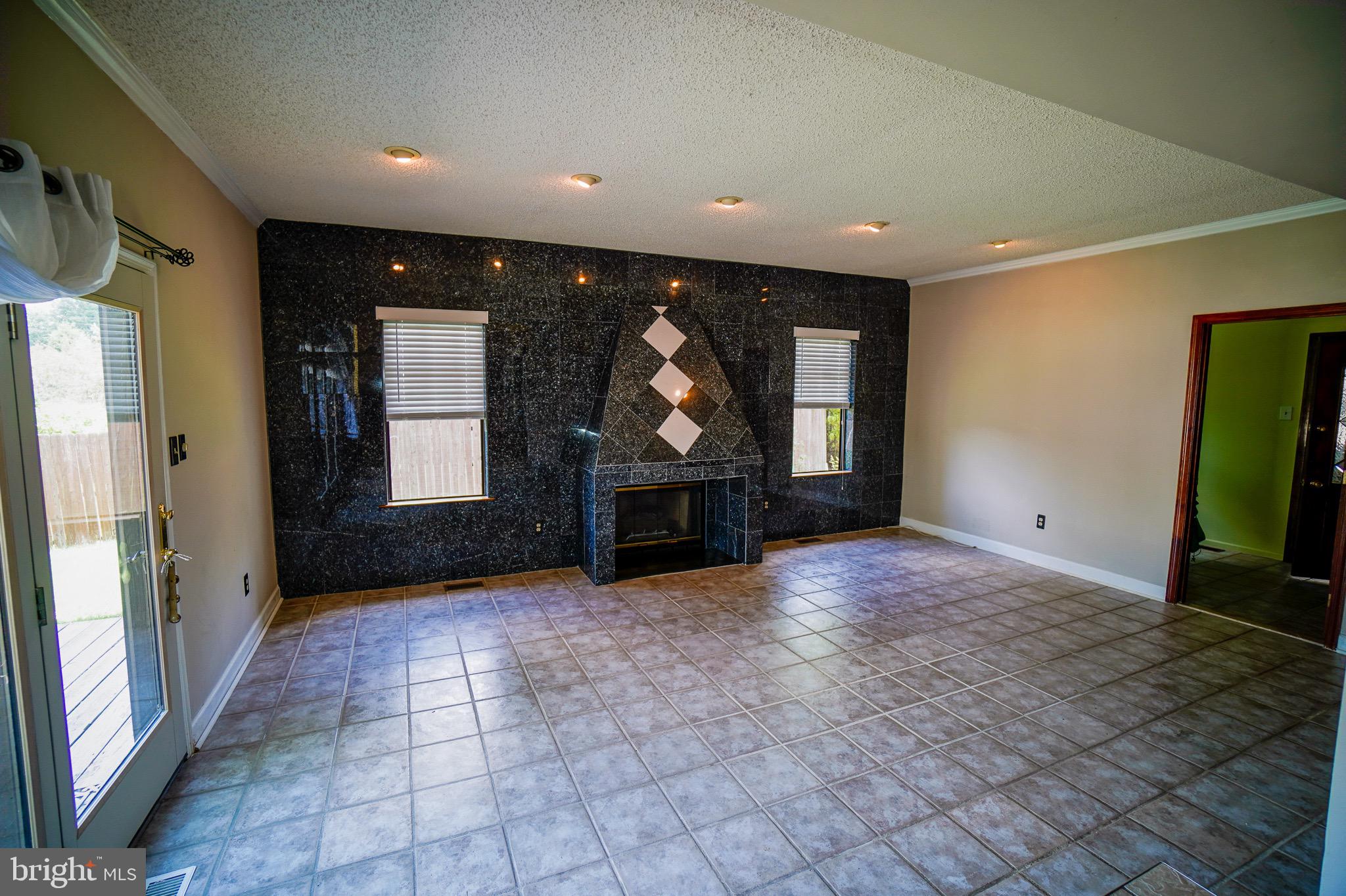 12 Blue Grass Road Clementon, NJ 08021 - Photo 10 of 23 a view of an empty room with a fireplace and a window