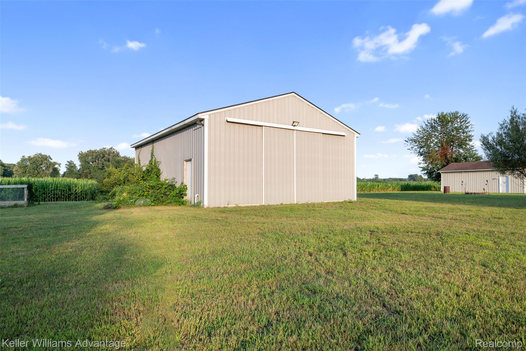 22627 Otter Road New Boston, MI 48164 - Photo 38 of 52 Spacious barn structure featuring corrugated metal siding and a large sliding entry door
