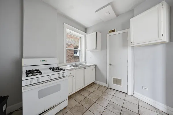 a kitchen with a stove sink and refrigerator