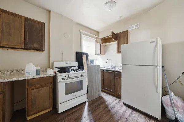 a kitchen with stainless steel appliances a stove a refrigerator and a microwave