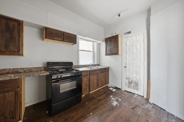 a utility room with a sink toilet and vanity