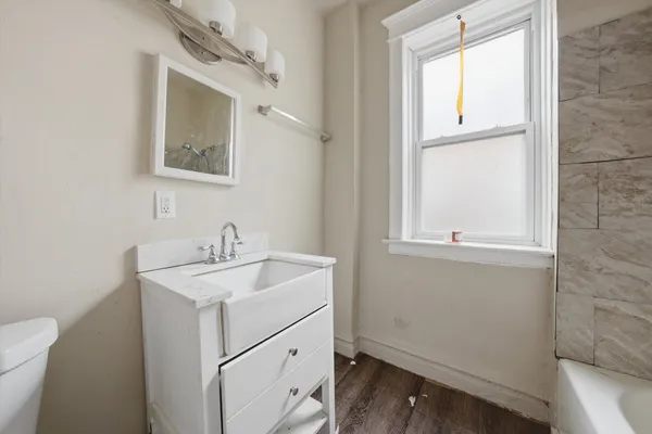 a bathroom with a sink toilet and mirror