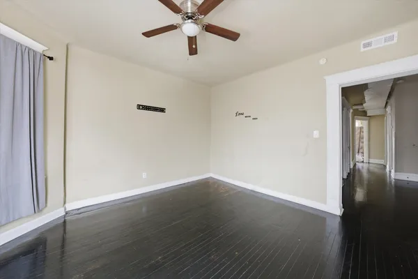 wooden floor in an empty room with a window