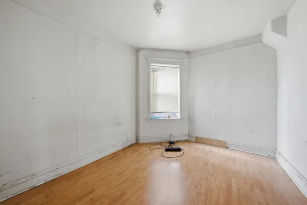 a view of livingroom with hardwood floor and white cabinet