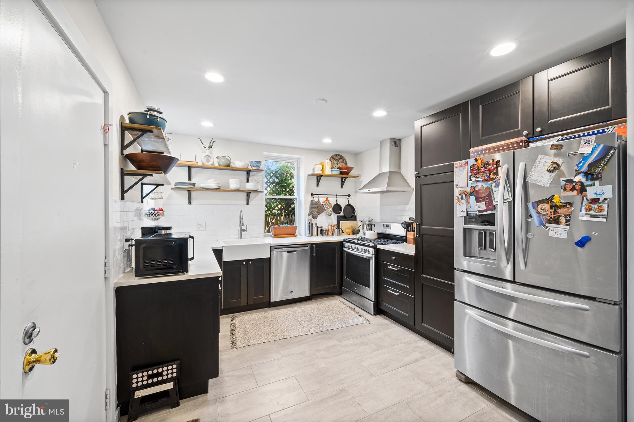 107 Master Street Philadelphia, PA 19122 - Photo 11 of 24 a kitchen with stainless steel appliances and refrigerator