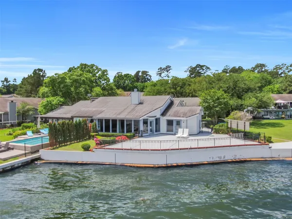an aerial view of a house with swimming pool garden and patio