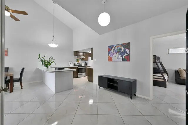 a living room with furniture a dining table and chairs