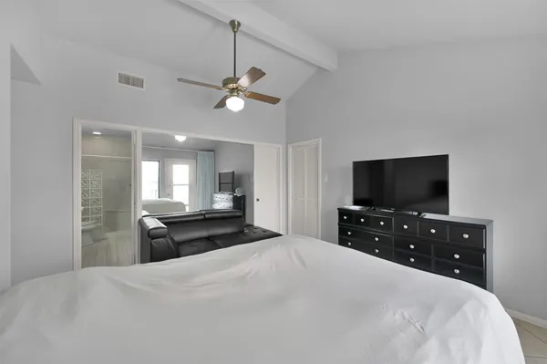 a bedroom with a bed and a flat screen tv