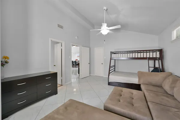 a living room with furniture and a ceiling fan