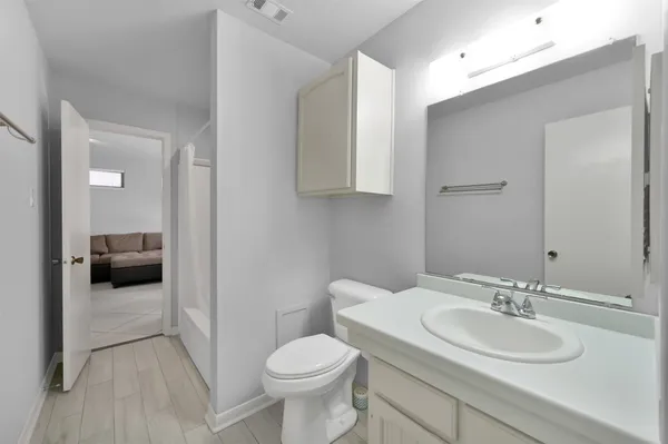 a bathroom with a sink toilet and a mirror
