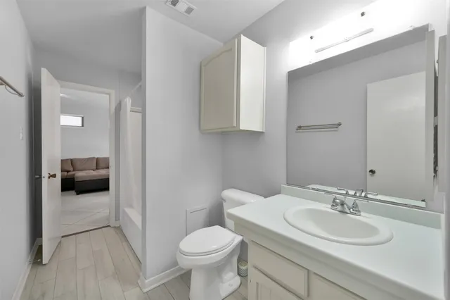 a bathroom with a sink toilet and a mirror