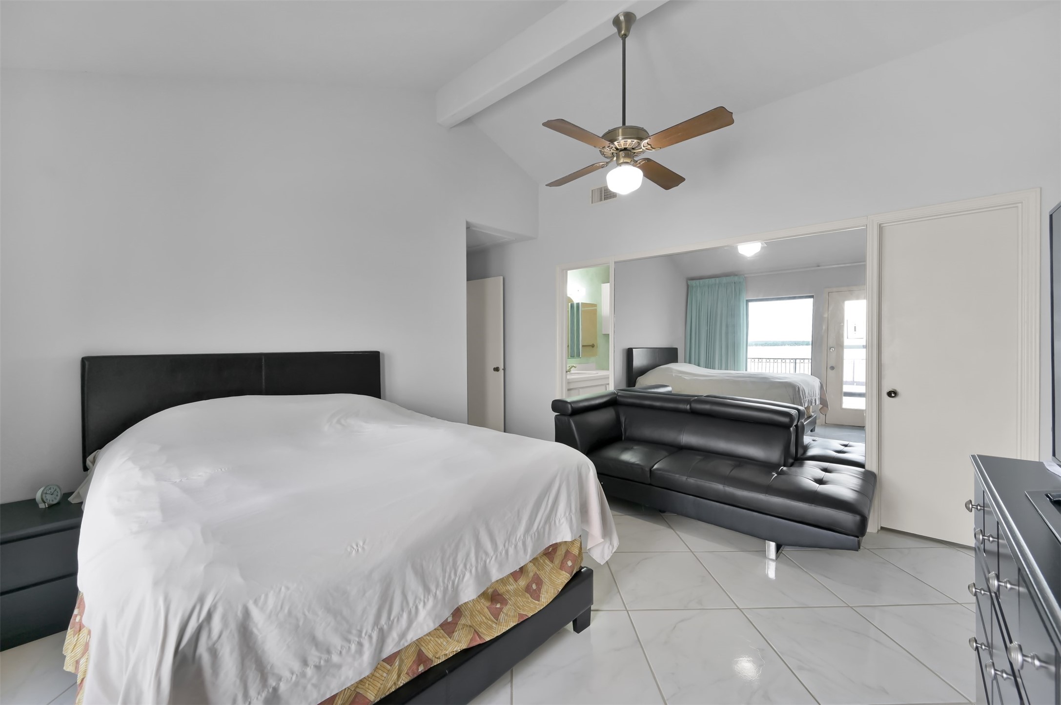 35 Lakeview Village Conroe, TX 77356 - Photo 20 of 34 a spacious bedroom with a bed and a chandelier