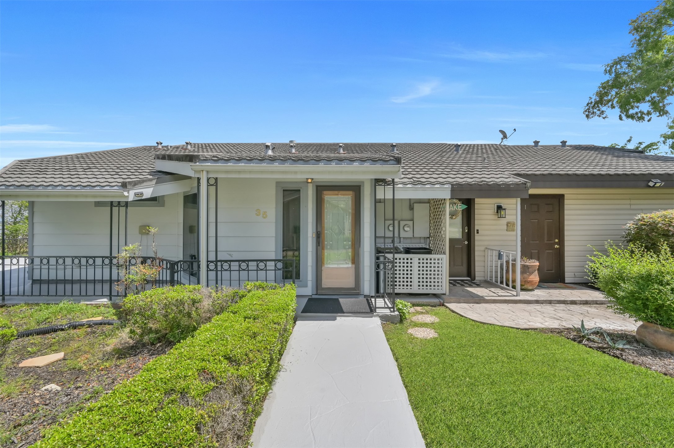 35 Lakeview Village Conroe, TX 77356 - Photo 2 of 34 a front view of a house with a yard