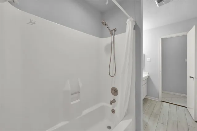 a bathroom with a bathtub and a shower