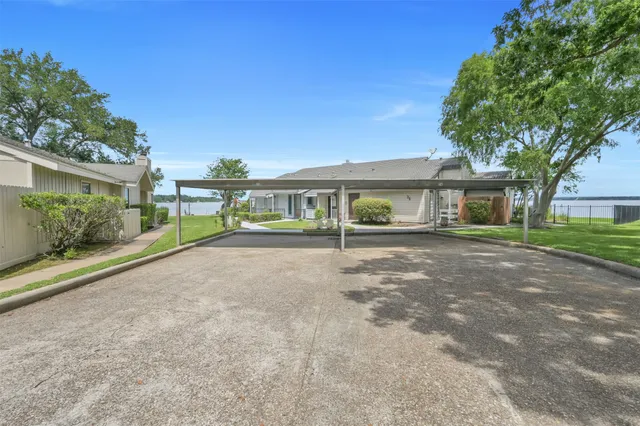 a view of a house with a yard and potted plants
