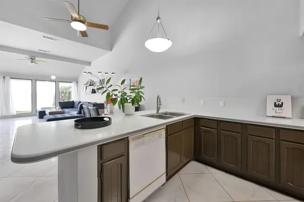 a kitchen with stainless steel appliances granite countertop a sink a counter space and cabinets
