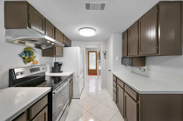 a kitchen with a sink appliances and cabinets