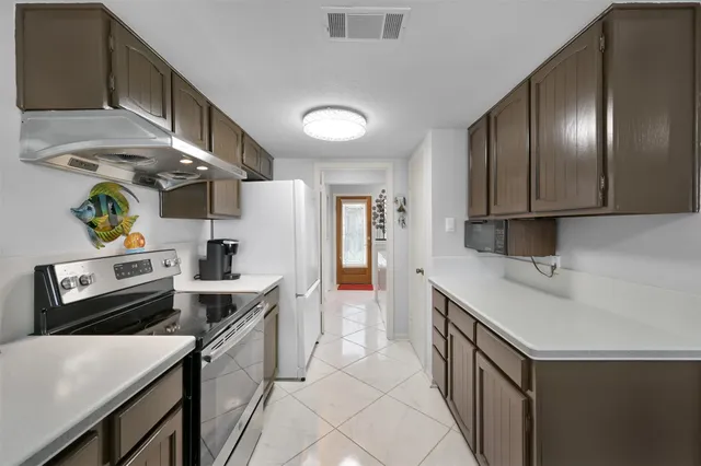 a kitchen with a sink appliances and cabinets
