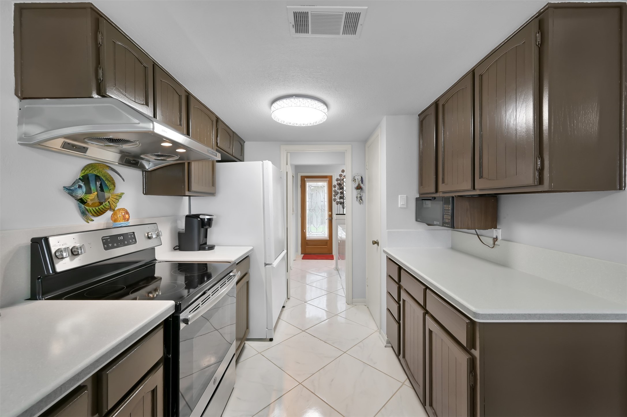 35 Lakeview Village Conroe, TX 77356 - Photo 6 of 34 a kitchen with a sink appliances and cabinets