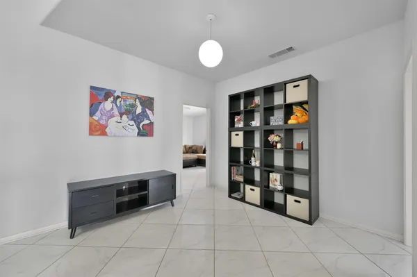 a view of an empty room with shelves and book shelf
