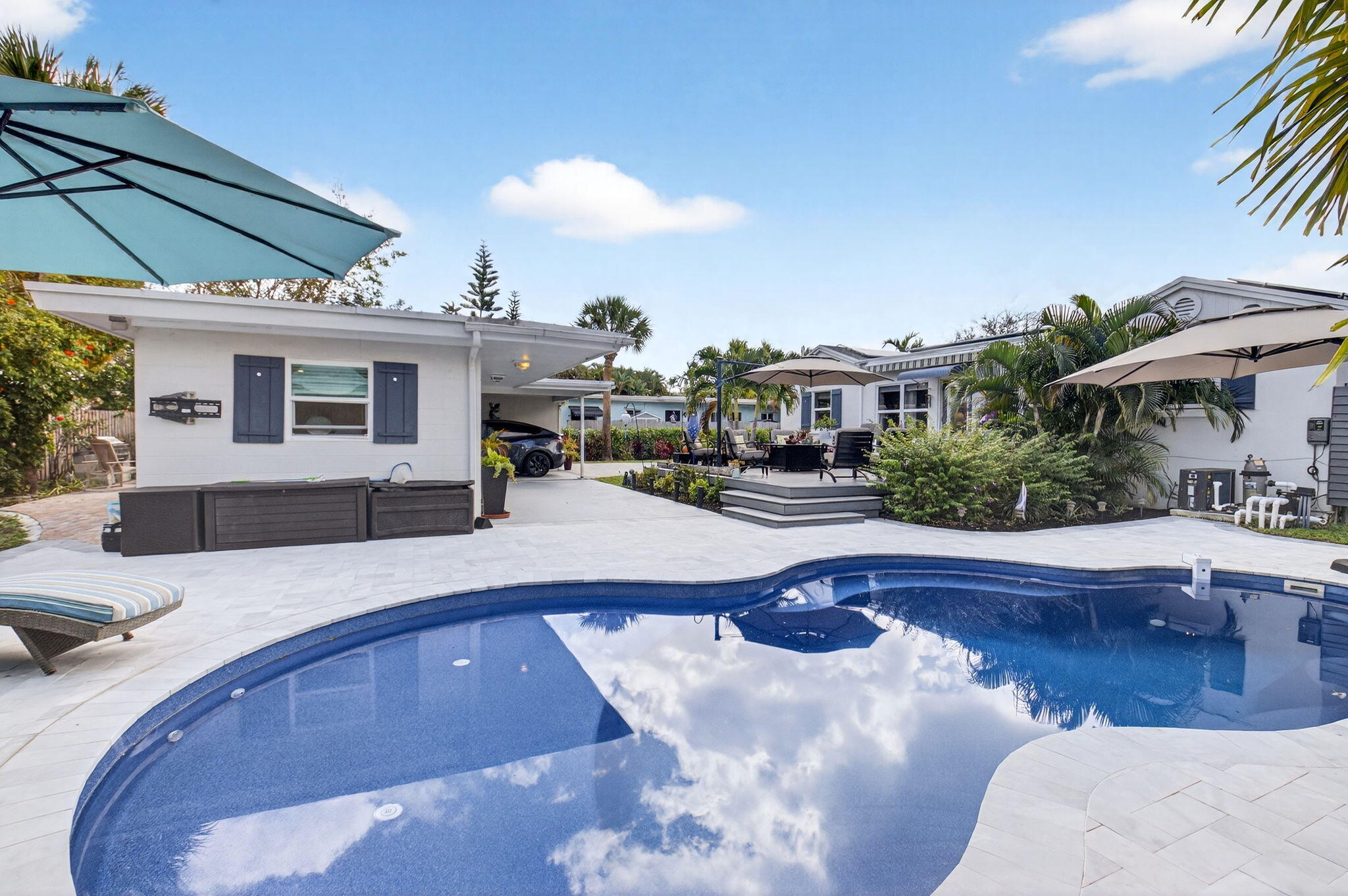 233 Northeast 12th Street Delray Beach, FL 33444 - Photo 1 of 55 a swimming pool with outdoor seating and yard