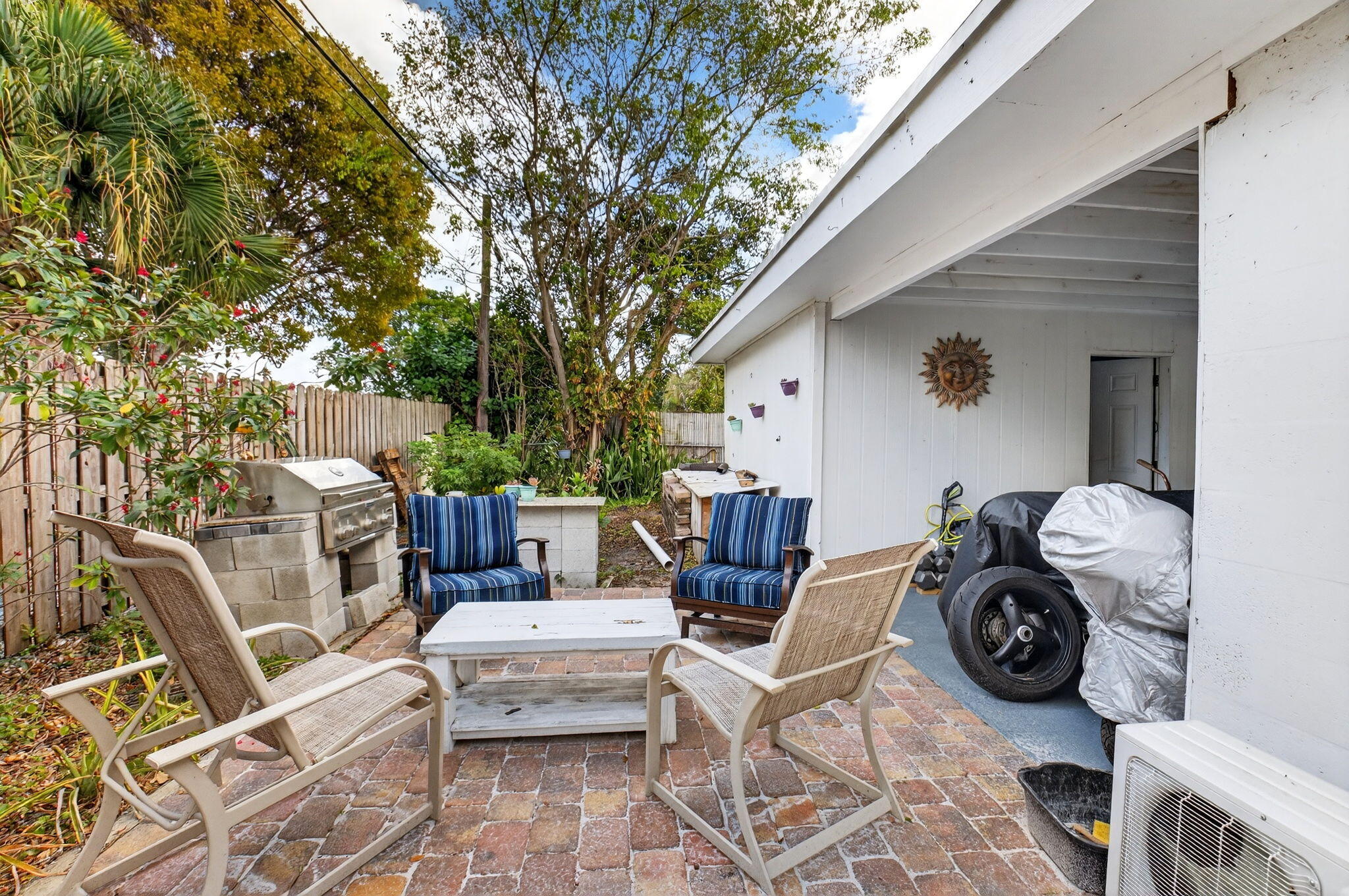233 Northeast 12th Street Delray Beach, FL 33444 - Photo 41 of 55 a backyard of a house with table and chairs