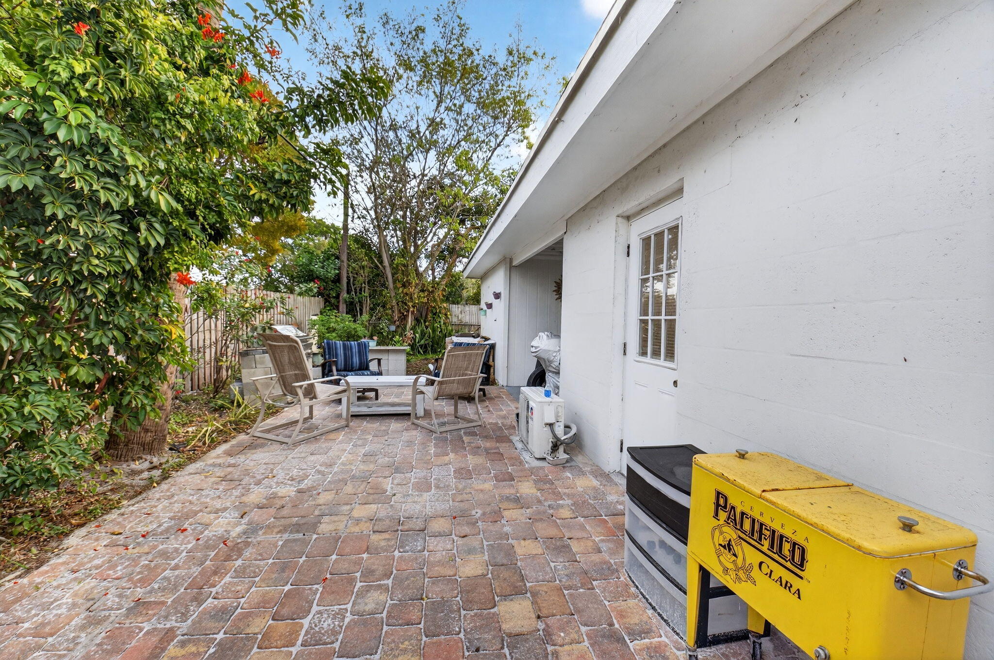 233 Northeast 12th Street Delray Beach, FL 33444 - Photo 42 of 55 a backyard of a house with table and chairs
