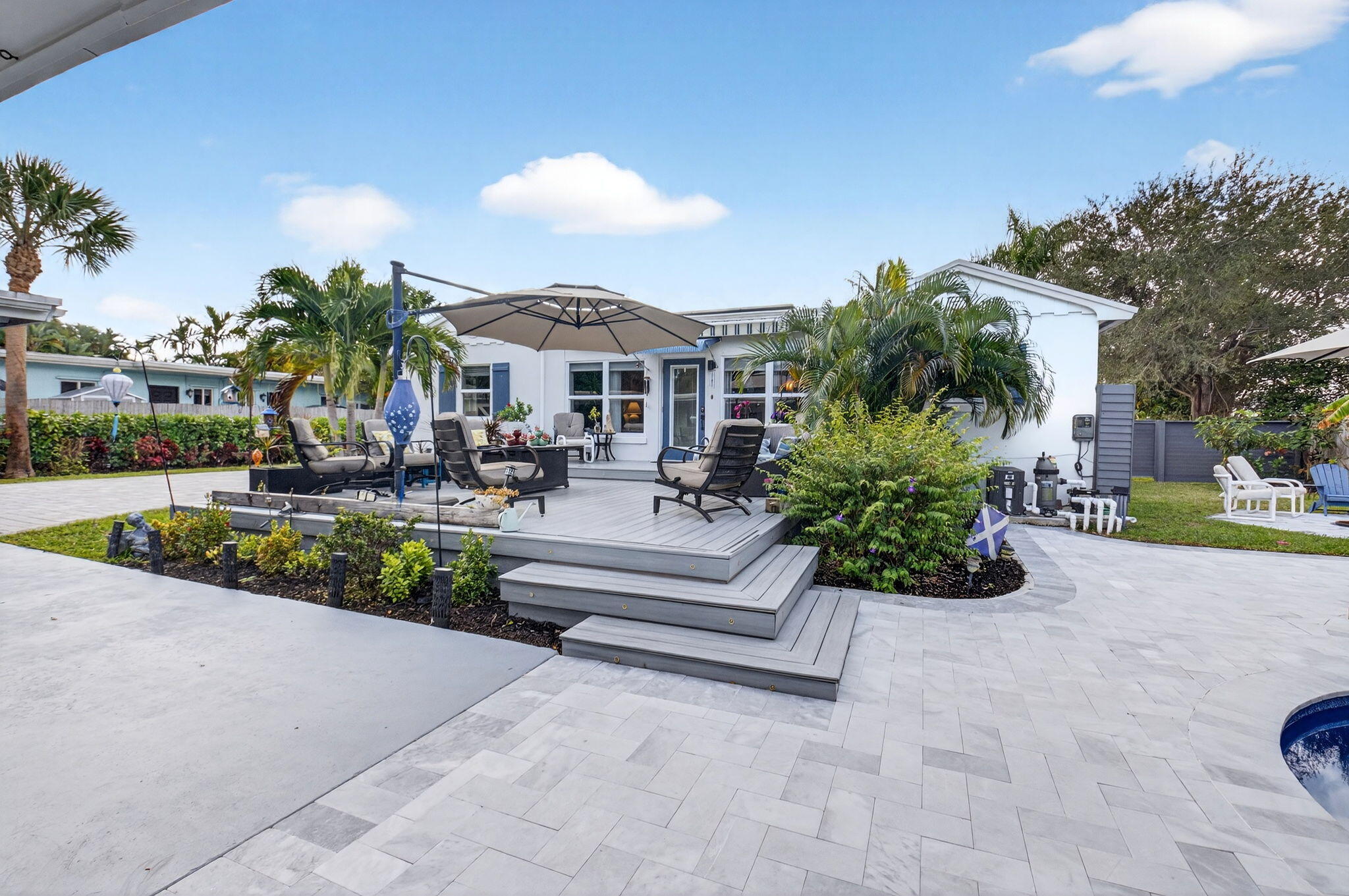 233 Northeast 12th Street Delray Beach, FL 33444 - Photo 44 of 55 a front view of a house with a garden and outdoor seating