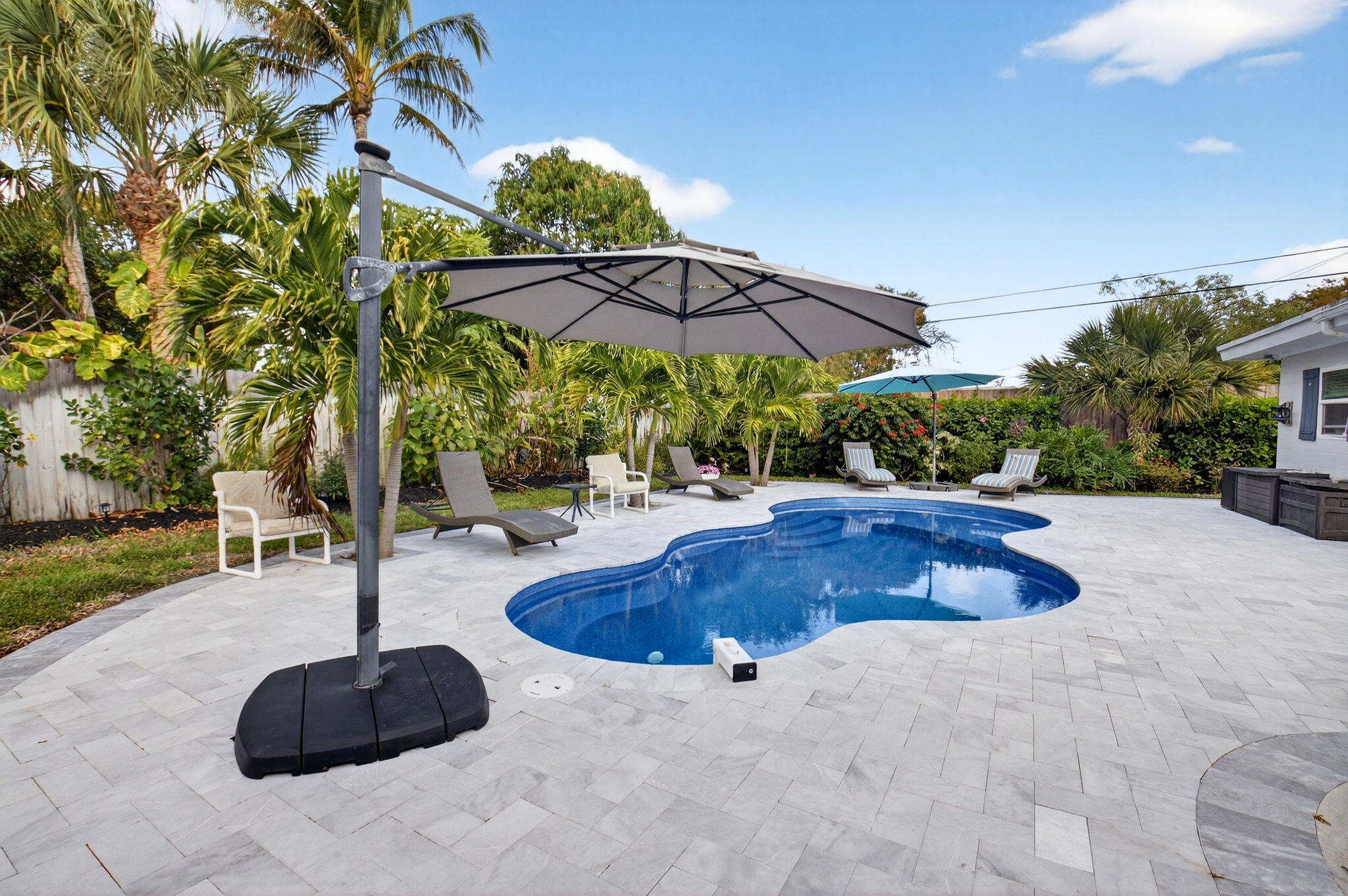 233 Northeast 12th Street Delray Beach, FL 33444 - Photo 47 of 55 a view of pool with table and chairs
