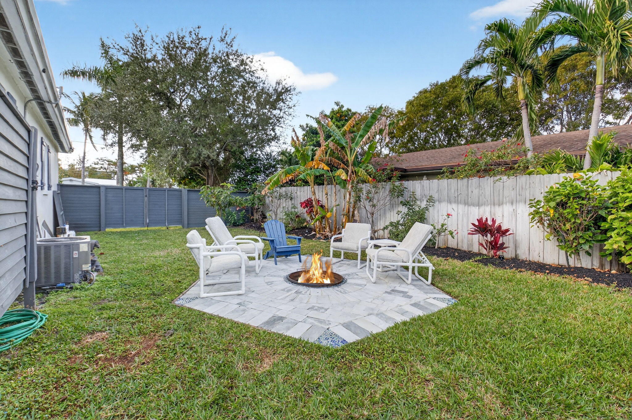 233 Northeast 12th Street Delray Beach, FL 33444 - Photo 48 of 55 a view of a backyard with a table and chairs