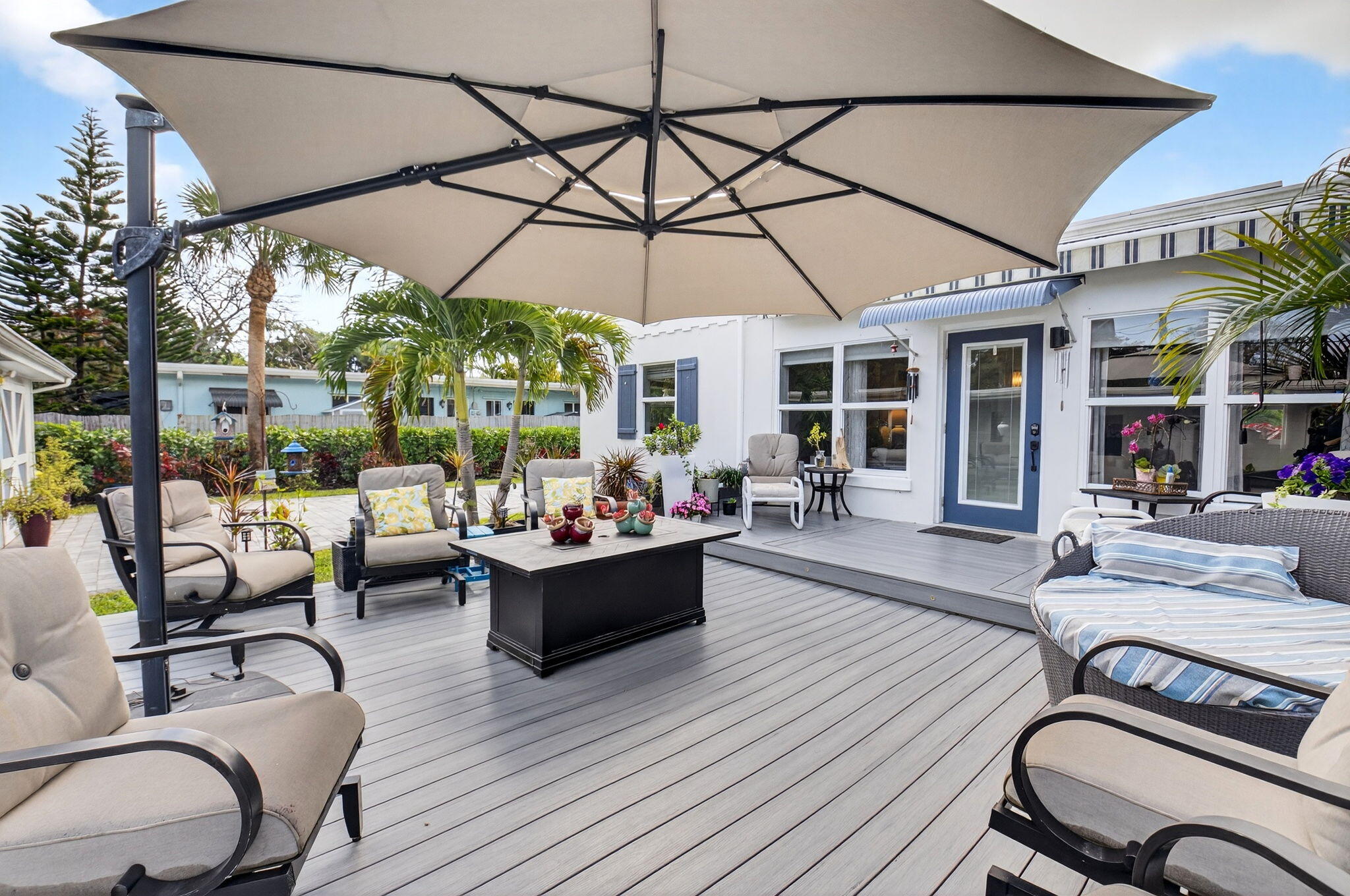 233 Northeast 12th Street Delray Beach, FL 33444 - Photo 54 of 55 a view of a patio with couches and table and chairs under an umbrella
