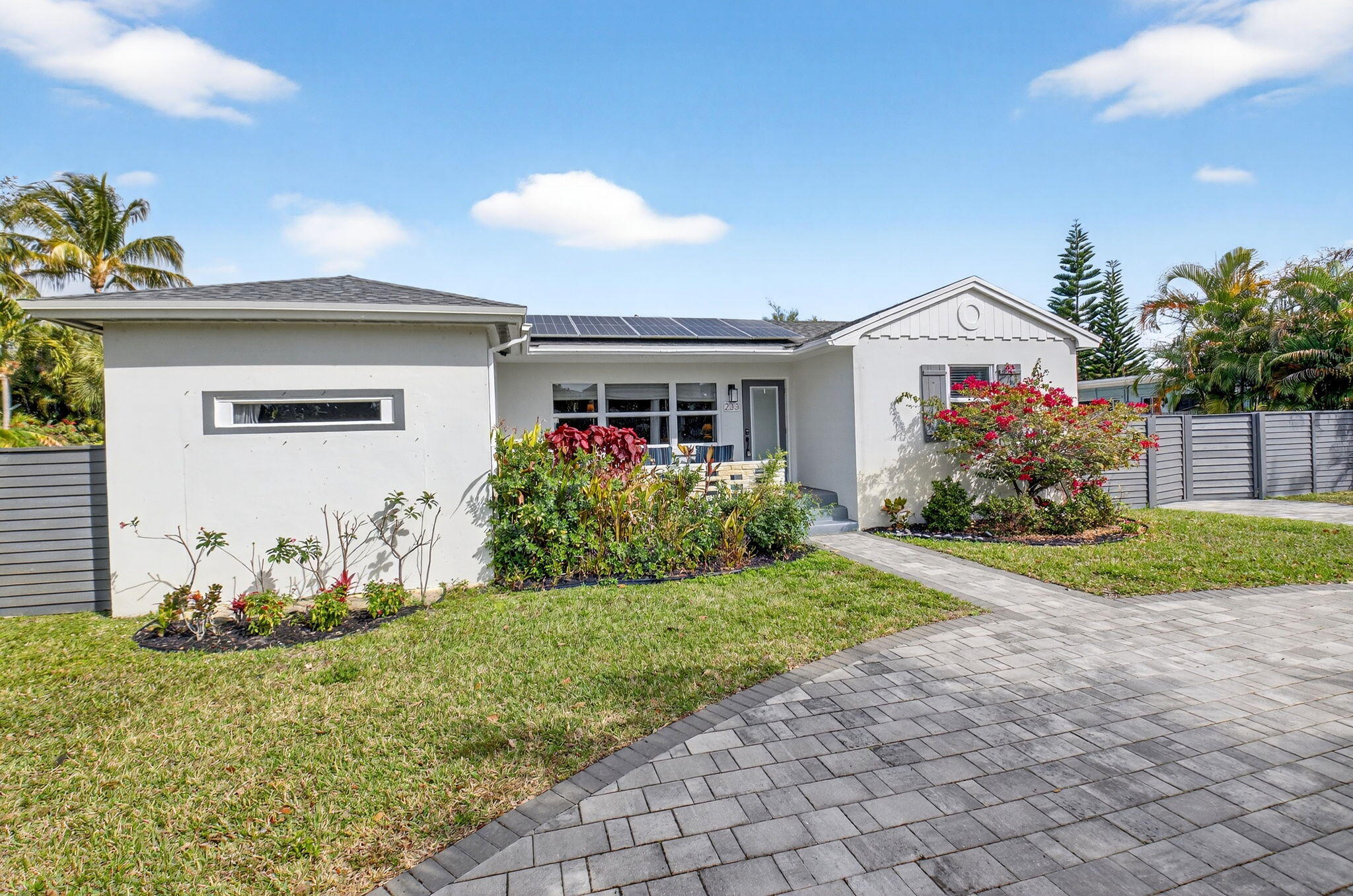 233 Northeast 12th Street Delray Beach, FL 33444 - Photo 8 of 55 a front view of a house with a yard