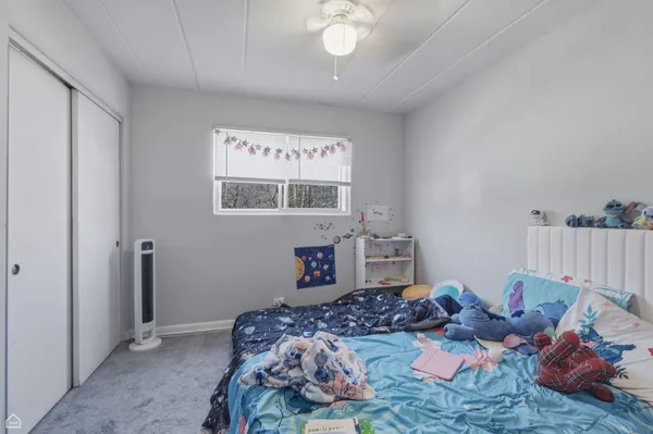 a bedroom with bed and a window