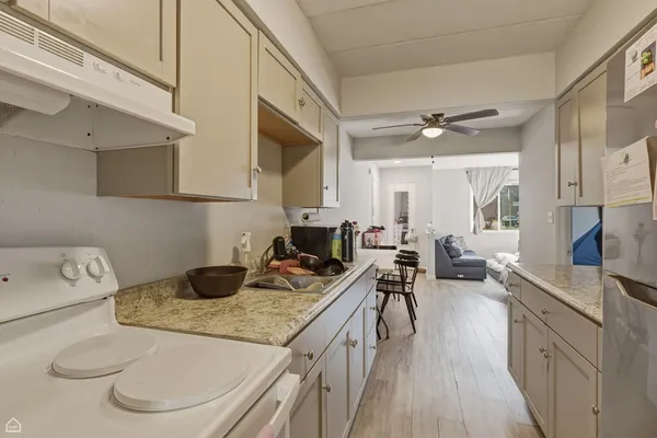 a kitchen with a sink a stove and cabinets