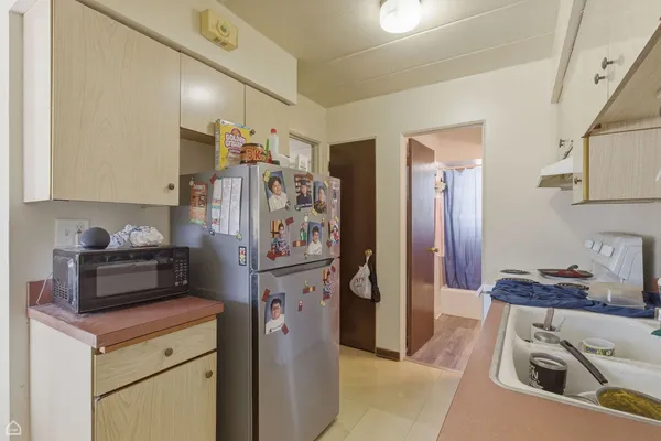 a kitchen with stainless steel appliances granite countertop a refrigerator and a stove top oven