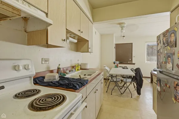 a kitchen with stainless steel appliances granite countertop a table and a stove top oven