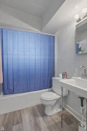 a bathroom with a toilet a sink and mirror