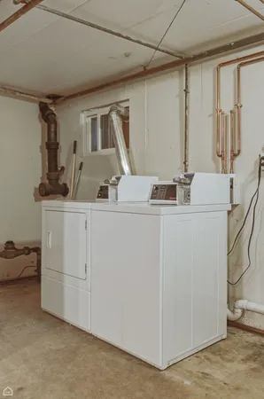 a room with cabinets and washer dryer