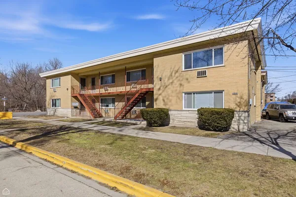 a view of a house with snow on the road