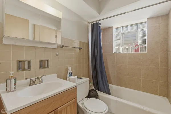 a bathroom with a sink toilet vanity and tub