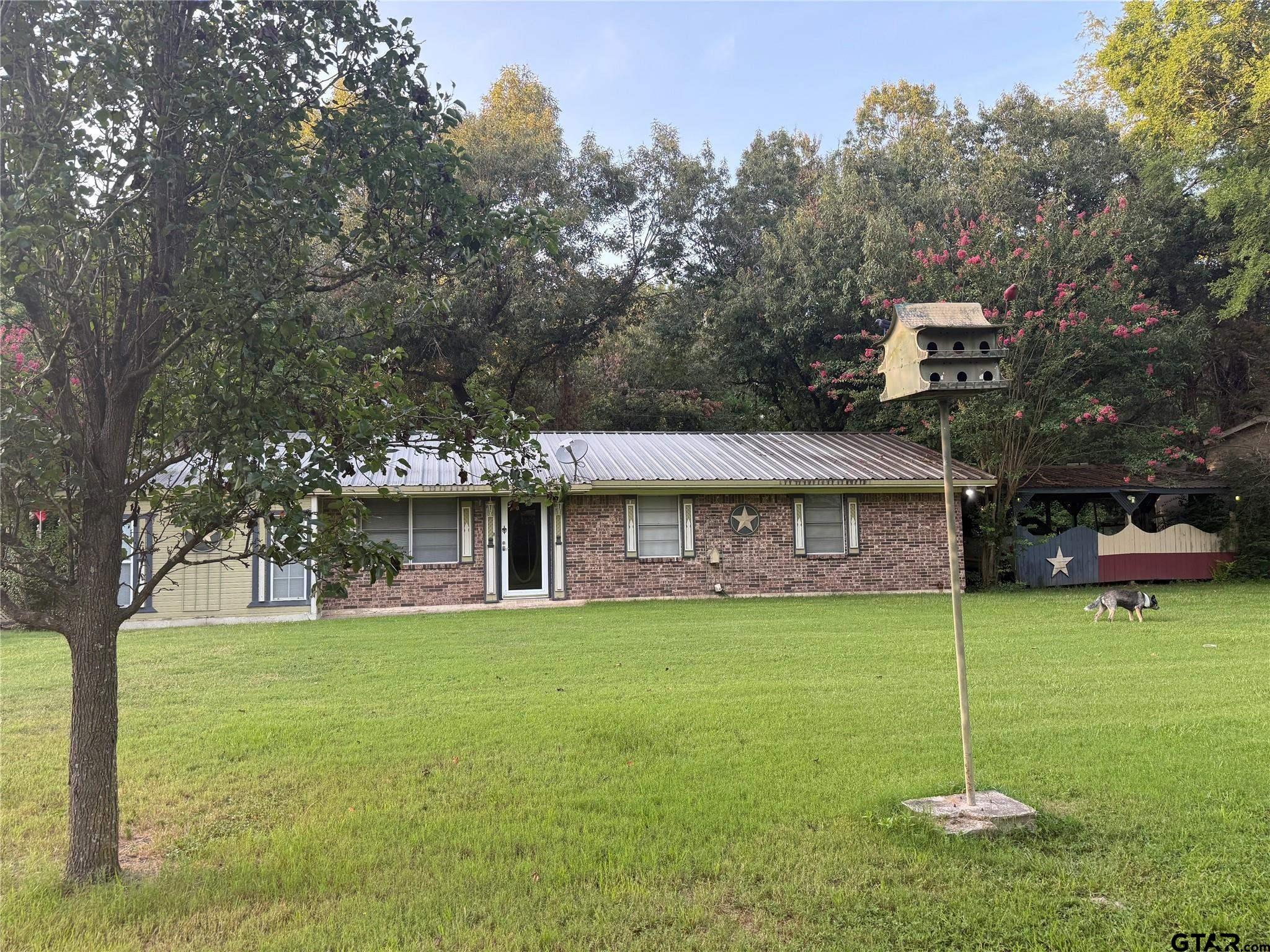 a view of a house with a yard porch and sitting area